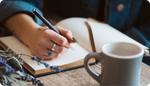 Person-writing-in-their-language-learning-journal